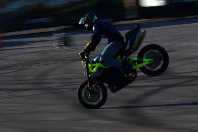 Freestyle motorcycle rider Nick Brocha performs in the parking lot of Sam Boyd Stadium during the Monster Energy Cup Saturday, Oct. 20, 2012.